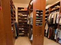 There are closets and there are closets! This custom designed and built walk-in master closet allows for total organization and maximum storage.